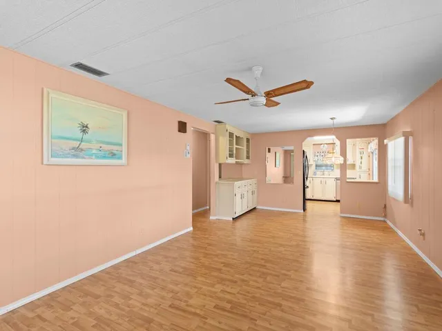 a kitchen with granite countertop a stove a sink and a refrigerator