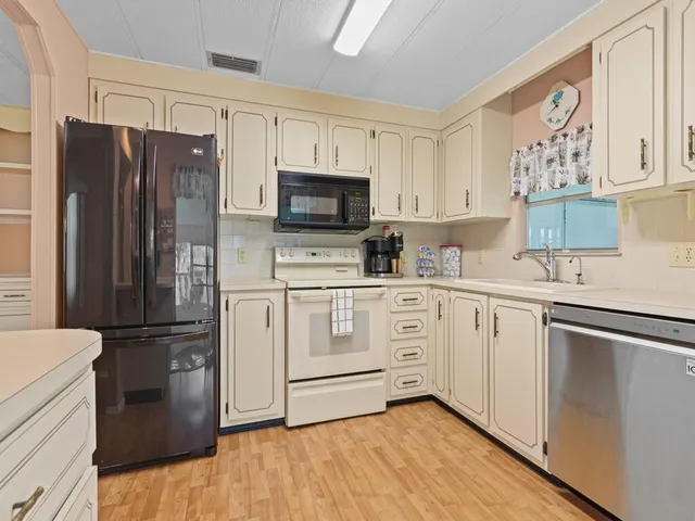 a kitchen with stainless steel appliances a refrigerator stove and microwave