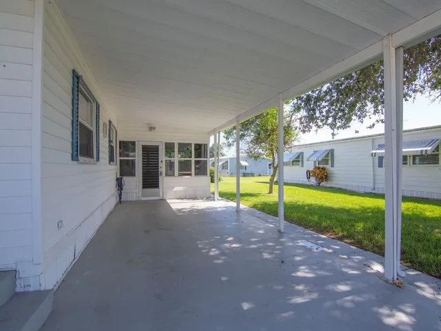 a view of a house with backyard and porch