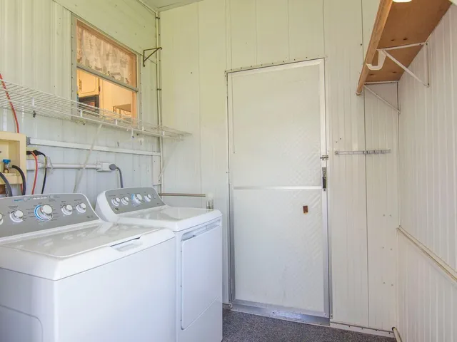 a view of storage and utility room with a sink and refrigerator
