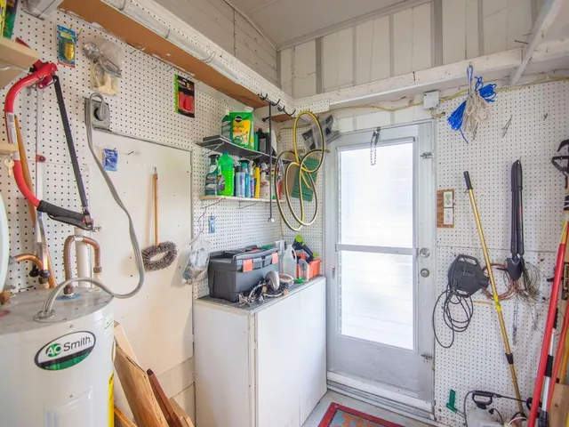 a storage room with kitchen island stainless steel appliances and wooden floor