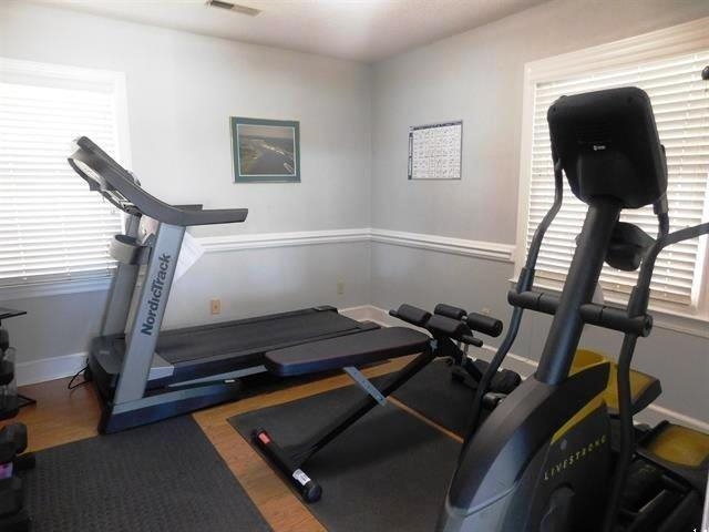 4396 Baldwin Avenue, Unit 82 Little River, SC 29566 - Photo 32 of 35 Workout area with baseboards and wood finished floors