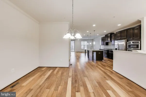 a view of a kitchen with wooden floor and a kitchen