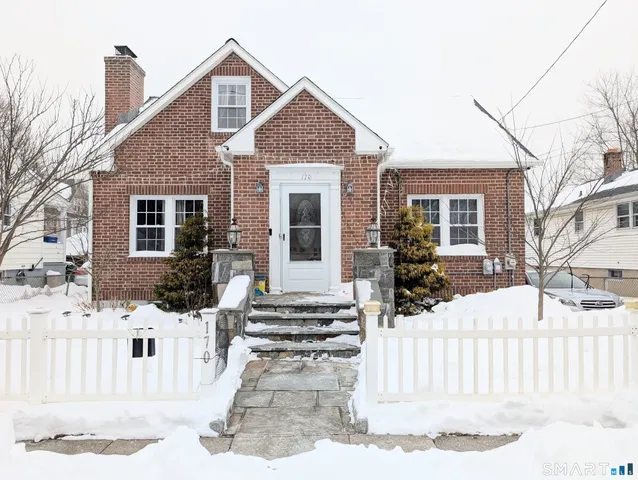 a front view of a house with a fence