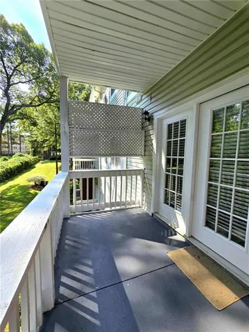 a view of a house with backyard porch and sitting area