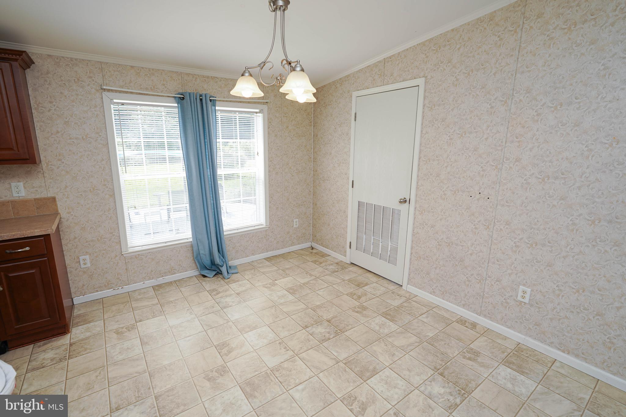 5846 Puckum Road Rhodesdale, MD 21659 - Photo 14 of 32 a view of an empty room with window and chandelier fan