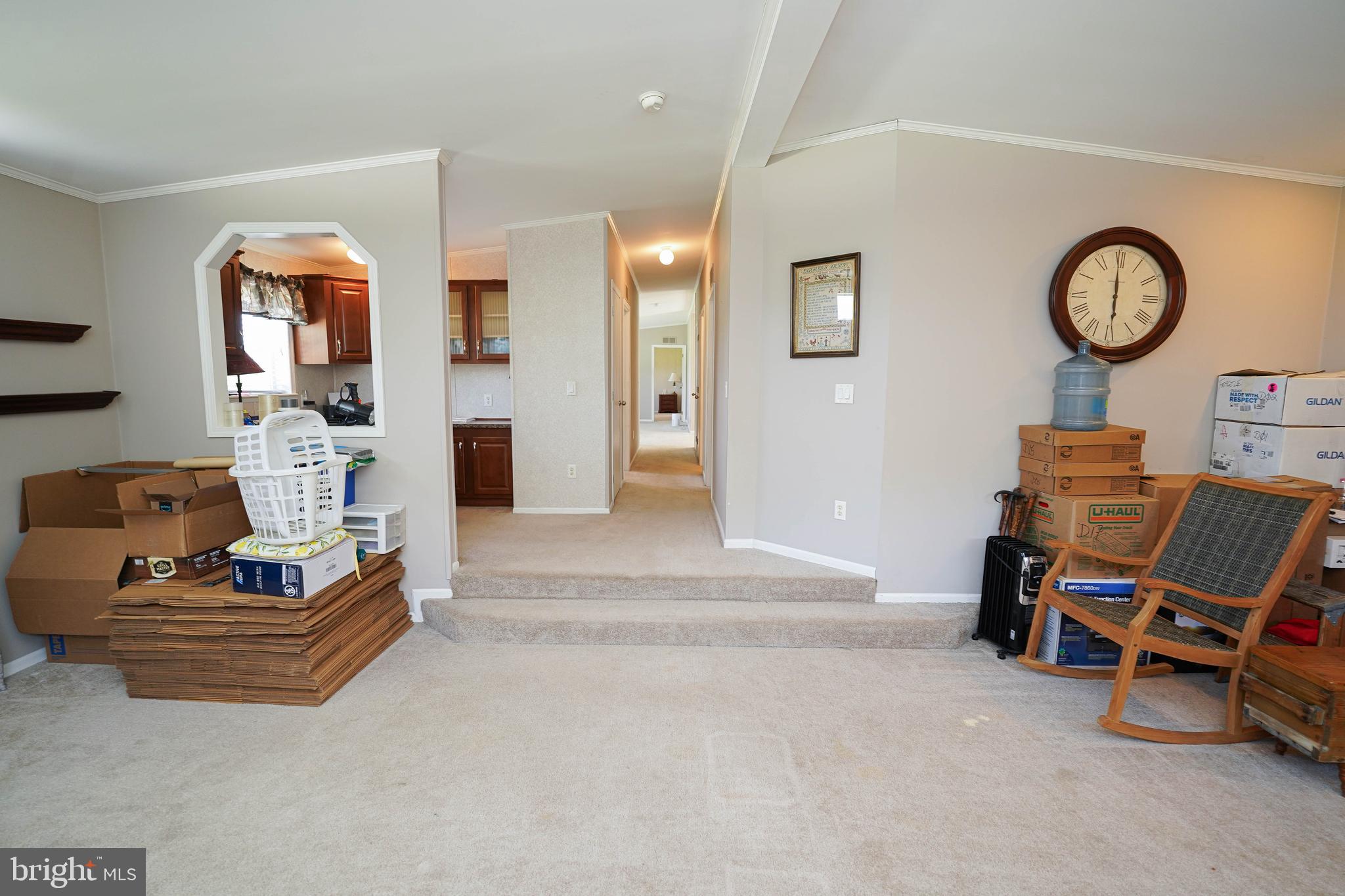 5846 Puckum Road Rhodesdale, MD 21659 - Photo 24 of 32 a living room with furniture a clock on wall and a window