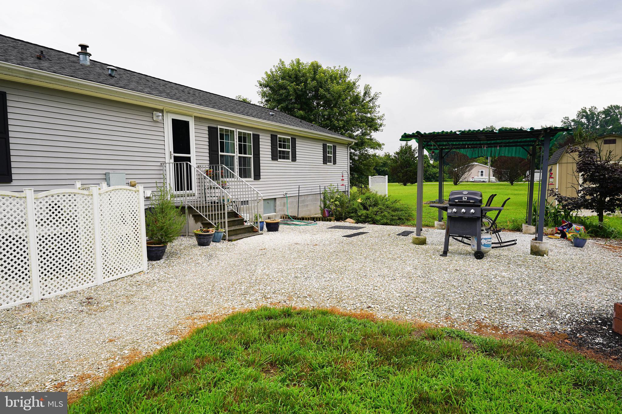 5846 Puckum Road Rhodesdale, MD 21659 - Photo 5 of 32 a backyard of a house with table and chairs
