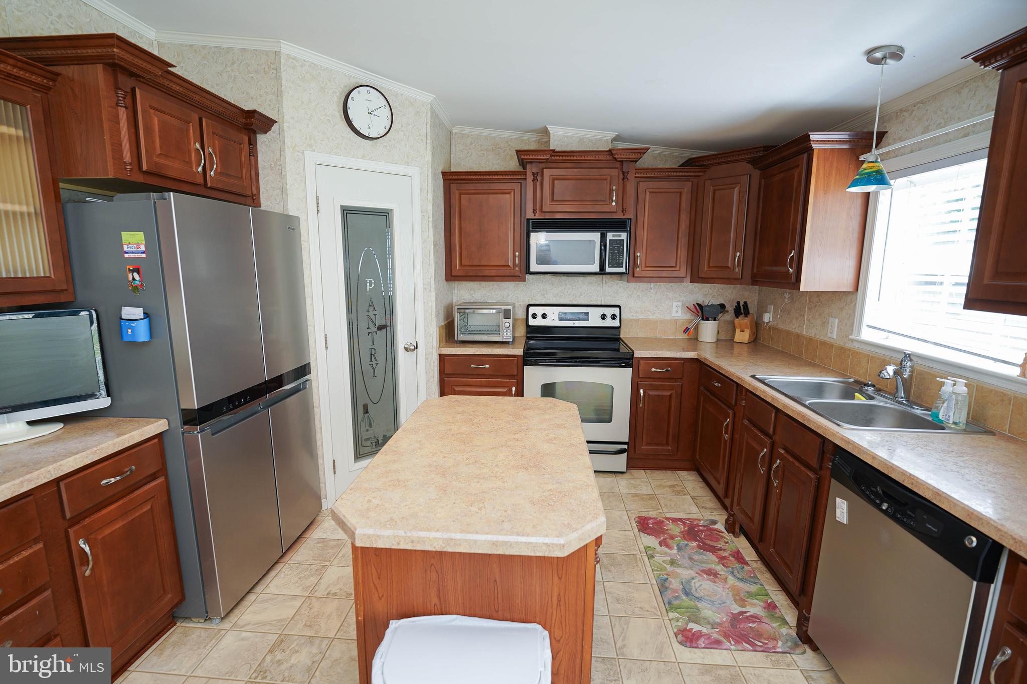 5846 Puckum Road Rhodesdale, MD 21659 - Photo 10 of 32 a kitchen with stainless steel appliances granite countertop a refrigerator a stove top oven a sink and dishwasher