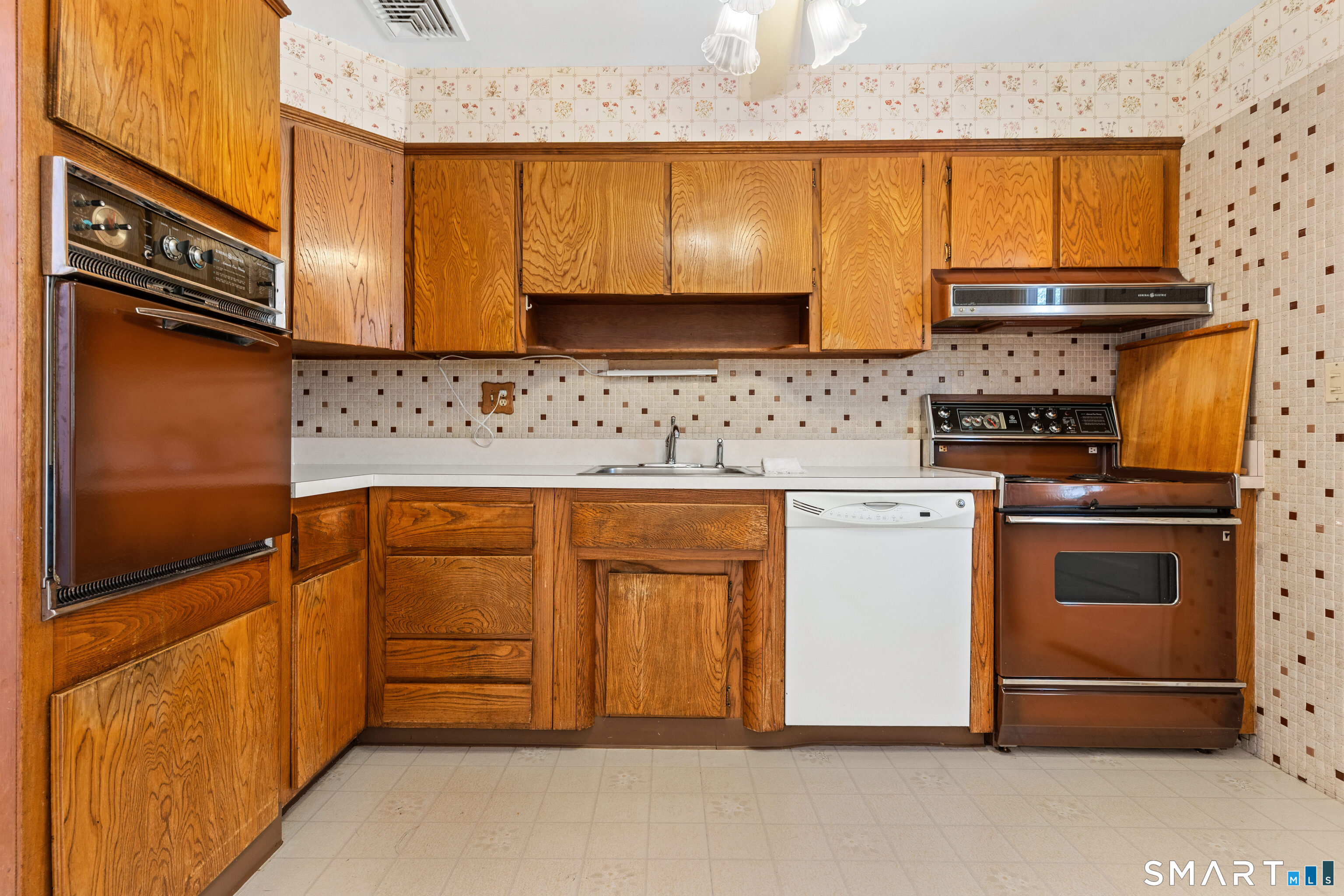251 Shelter Rock Road Fairfield, CT 06825 - Photo 17 of 38 a kitchen with stainless steel appliances granite countertop a stove a sink and a microwave