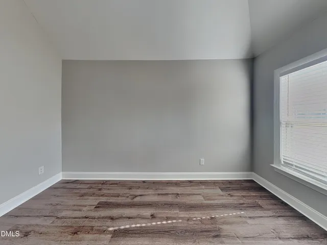 a view of a room with wooden floor and cabinet