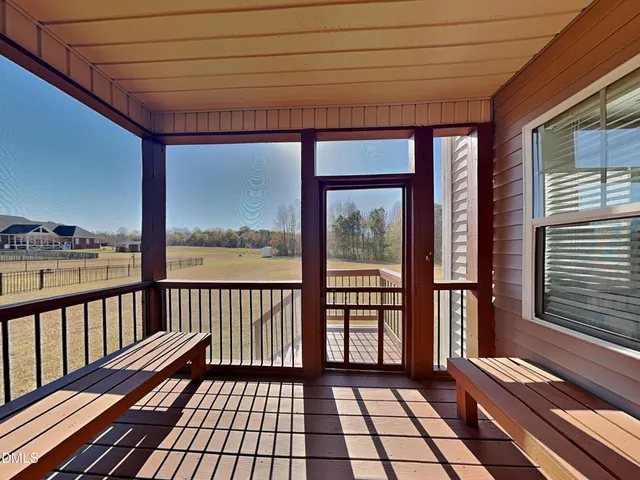 a view of a balcony with wooden floor
