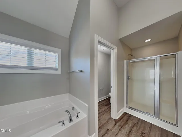 a bathroom with a bathtub and a shower