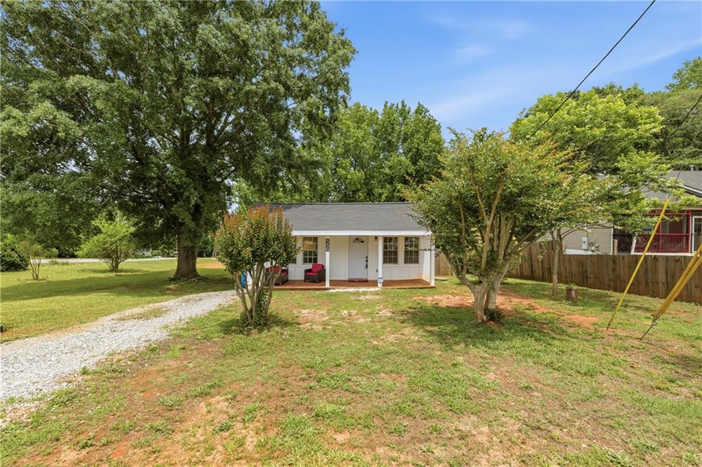 156 Pine Avenue Commerce, GA 30529 - Photo 6 of 35 a view of a house with backyard and tree