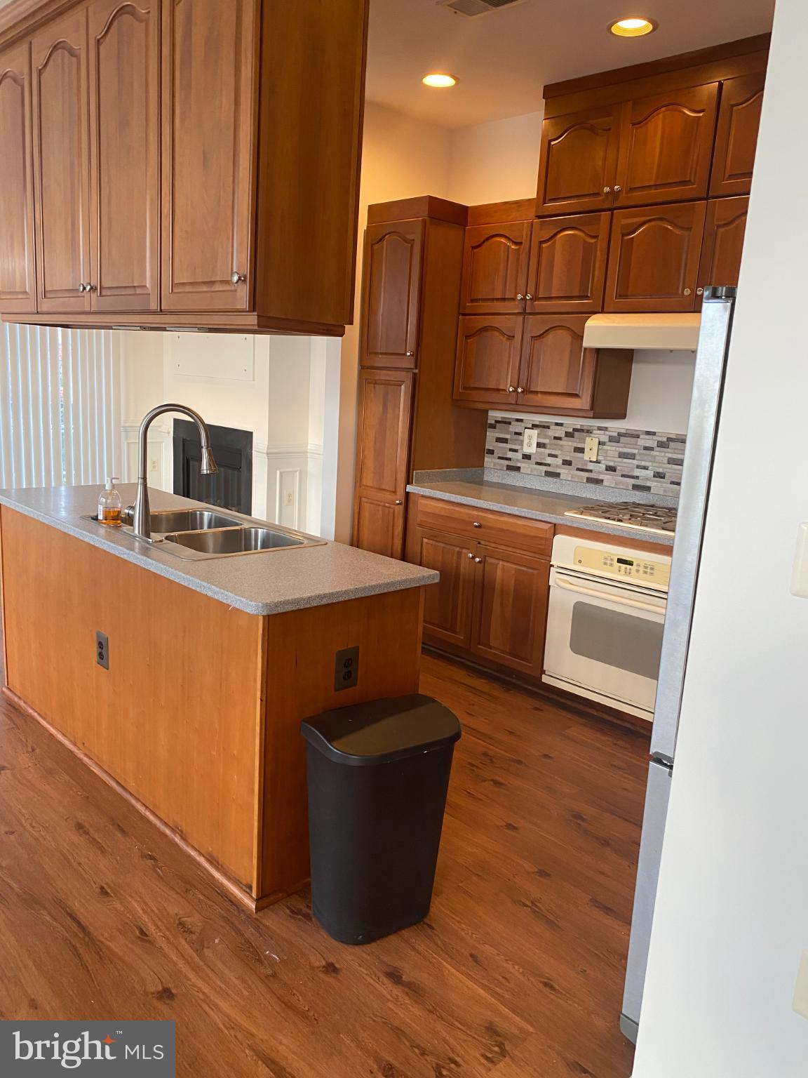 820 Belmont Bay Drive, Unit 301 Woodbridge, VA 22191 - Photo 12 of 76 Warm wood tones in a spacious kitchen.