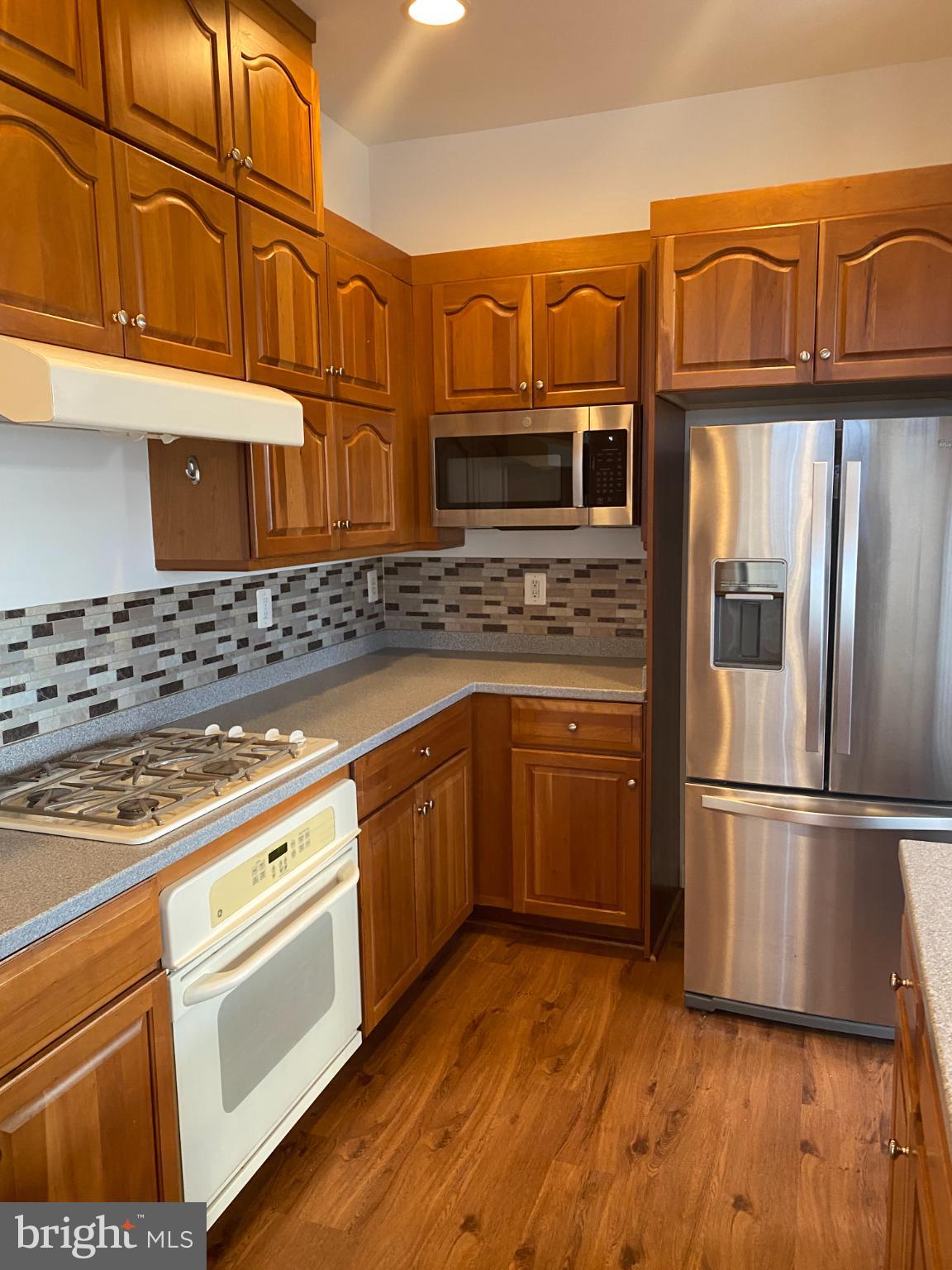 820 Belmont Bay Drive, Unit 301 Woodbridge, VA 22191 - Photo 8 of 76 Warm wood tones in a modern kitchen.