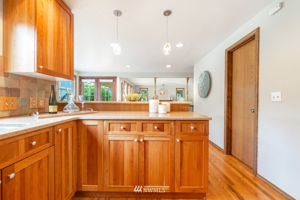 560 North 76th Street Seattle, WA 98103 - Photo 14 of 37 a kitchen with stainless steel appliances a sink and cabinets