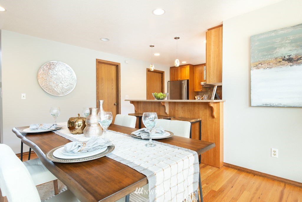 560 North 76th Street Seattle, WA 98103 - Photo 17 of 37 a view of a dining room with furniture and wooden floor