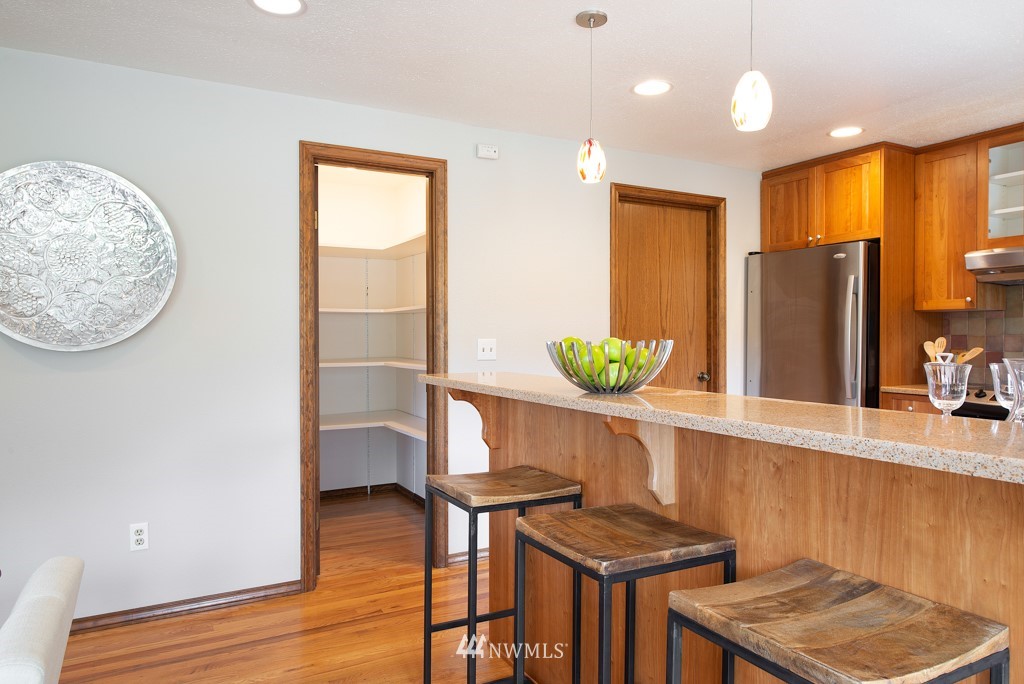 560 North 76th Street Seattle, WA 98103 - Photo 18 of 37 a view of a kitchen with furniture and wooden floor