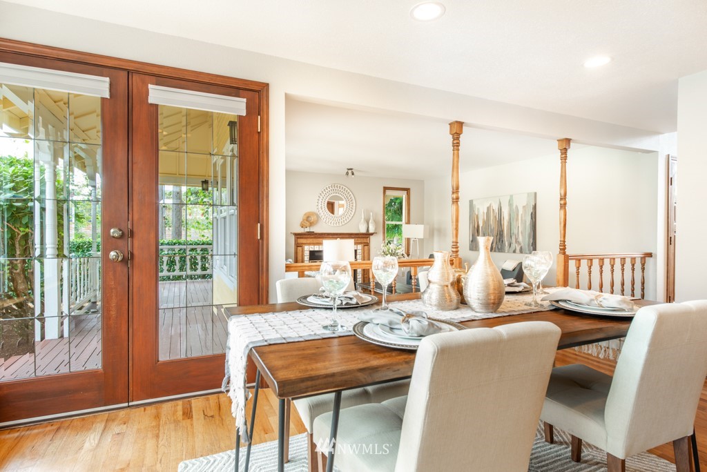 560 North 76th Street Seattle, WA 98103 - Photo 19 of 37 a dining room with furniture a chandelier and wooden floor