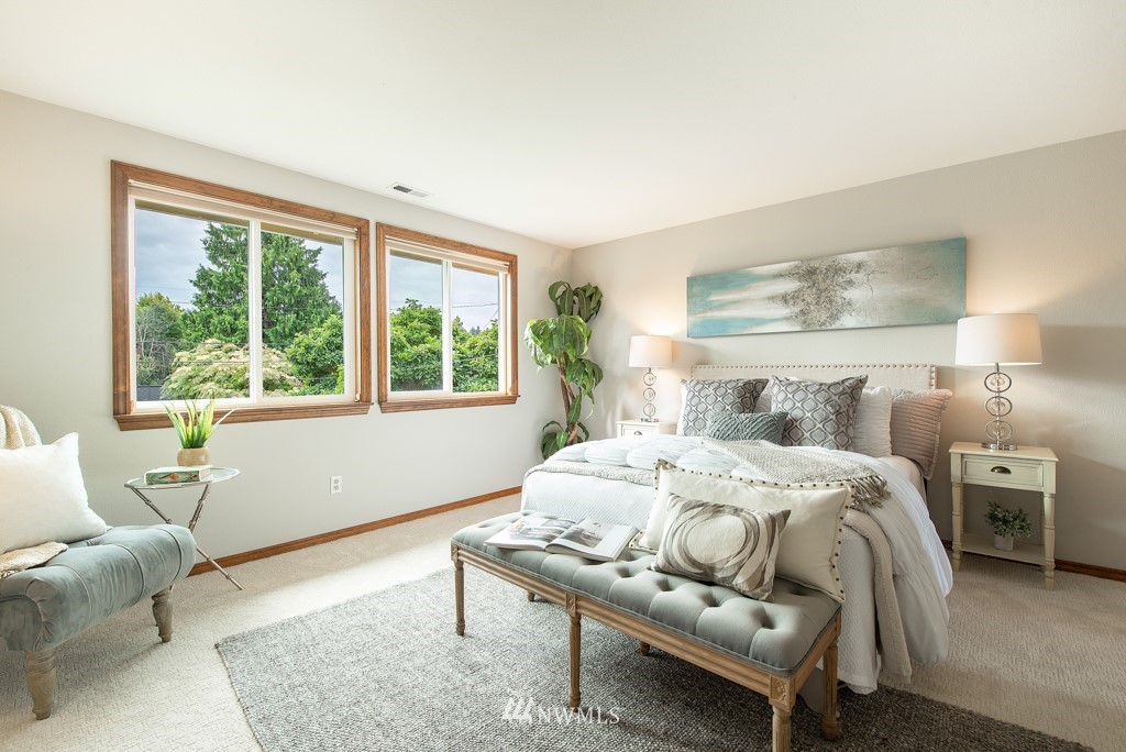 560 North 76th Street Seattle, WA 98103 - Photo 22 of 37 a bedroom with a bed and wooden floor