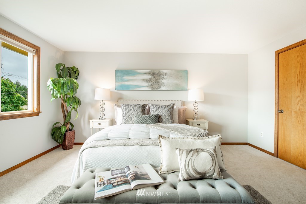 560 North 76th Street Seattle, WA 98103 - Photo 23 of 37 a bedroom with a bed and window