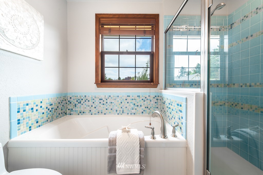 560 North 76th Street Seattle, WA 98103 - Photo 24 of 37 a bathroom with a bathtub and window