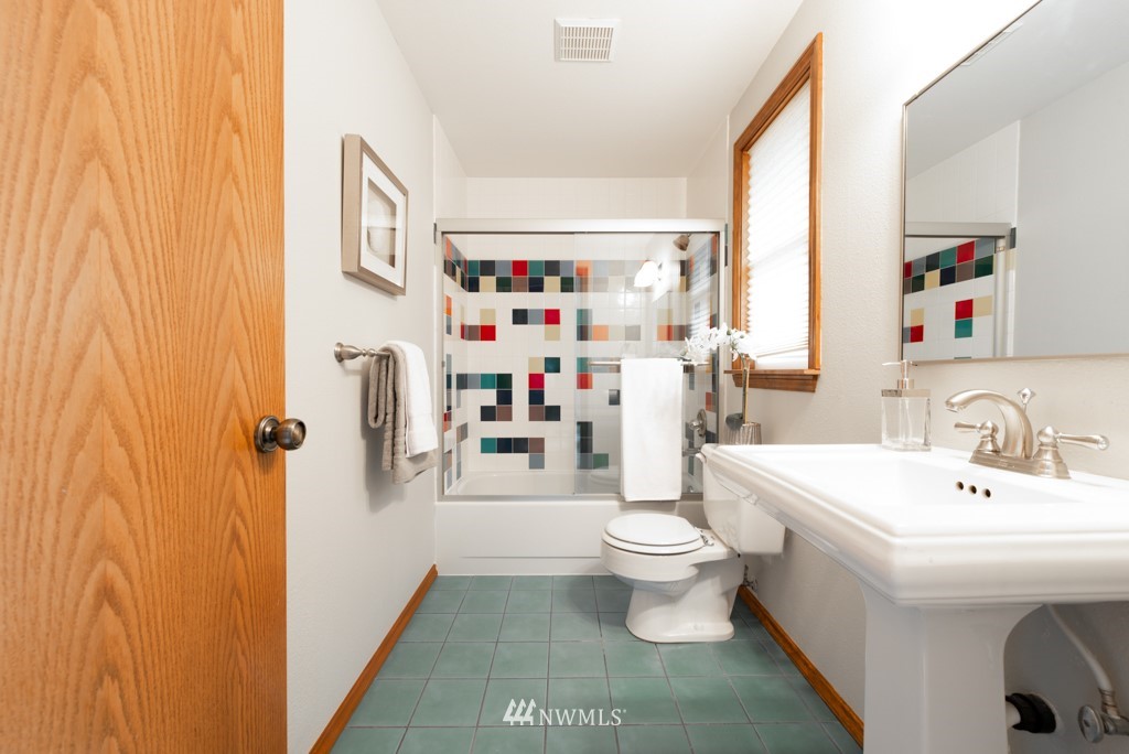 560 North 76th Street Seattle, WA 98103 - Photo 29 of 37 a bathroom with a sink toilet and a shower