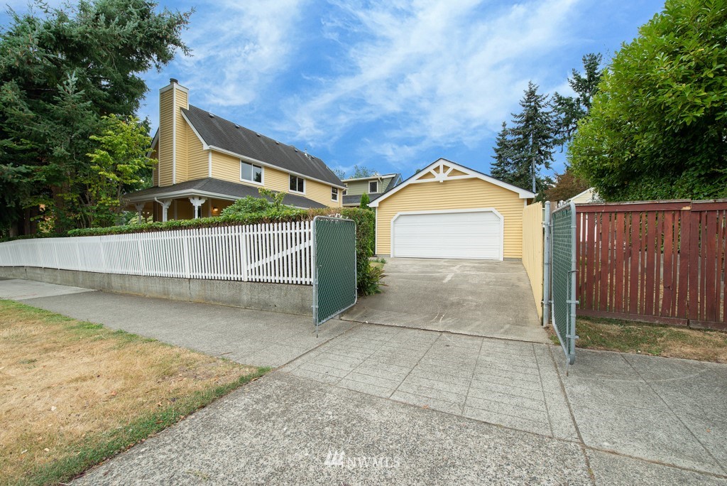 560 North 76th Street Seattle, WA 98103 - Photo 35 of 37 a front view of a house with a yard and garage