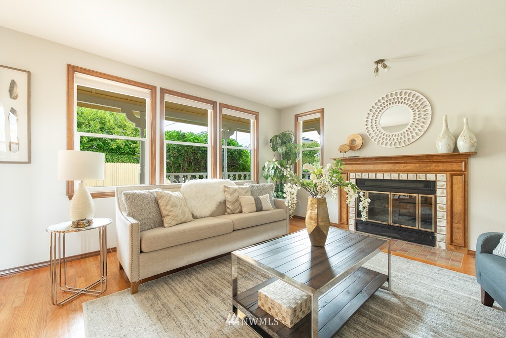560 North 76th Street Seattle, WA 98103 - Photo 6 of 37 a living room with furniture a large window and a fireplace