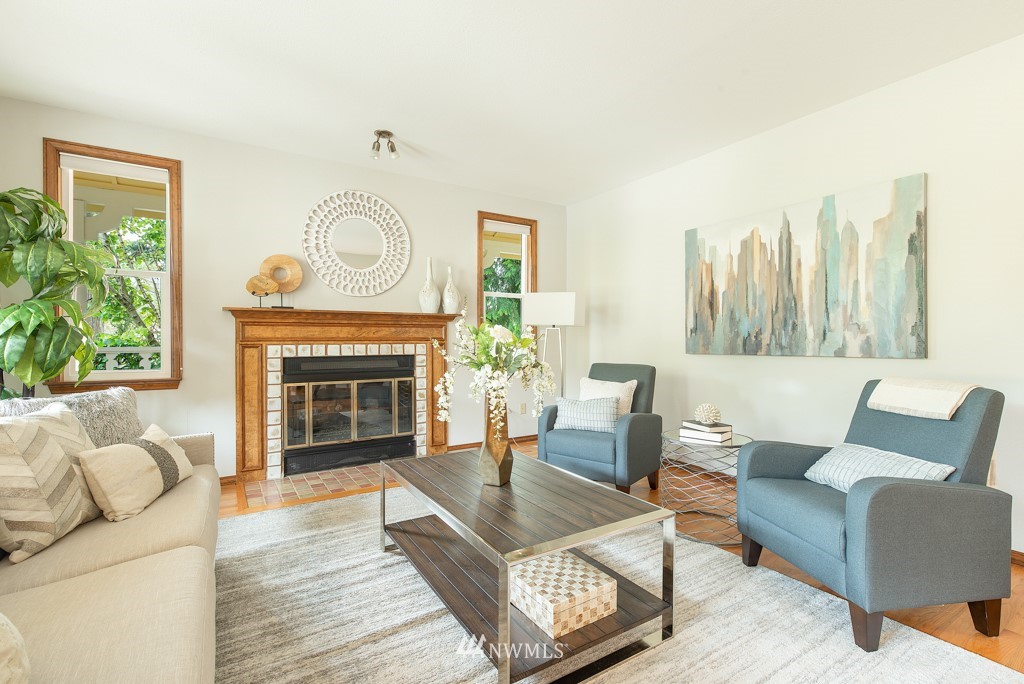 560 North 76th Street Seattle, WA 98103 - Photo 7 of 37 a living room with furniture a large window and a fireplace