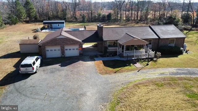 a view of a house with swimming pool and sitting area