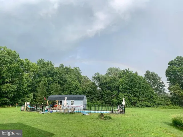 a view of house with a yard