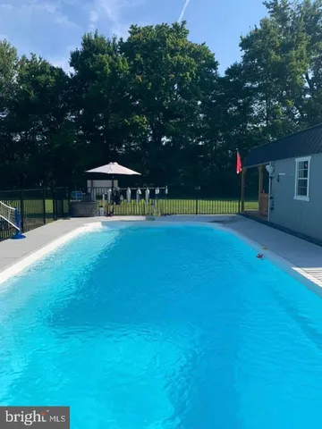 a swimming pool with a trees in the background