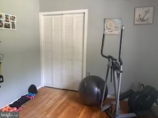 a view of a workspace with furniture and gym equipment