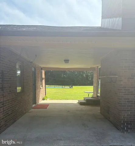 a view of an empty room and a window
