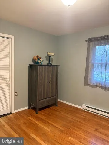 a view of a room with wooden floor and closet