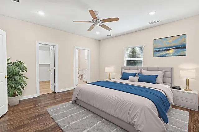 a bedroom with a large bed and a window