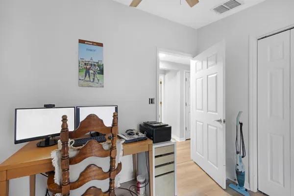 a view of a workspace with furniture and wooden floor