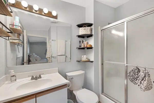 a bathroom with a sink toilet and shower