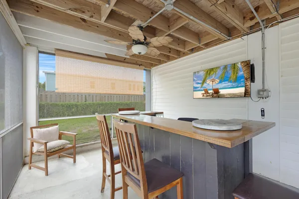 a view of a dining room with furniture a chandelier and wooden floor