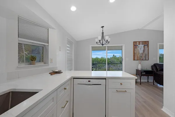 a spacious bathroom with a sink a large mirror and a window