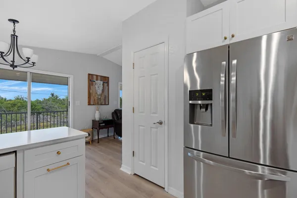 a kitchen with stainless steel appliances a refrigerator and cabinets