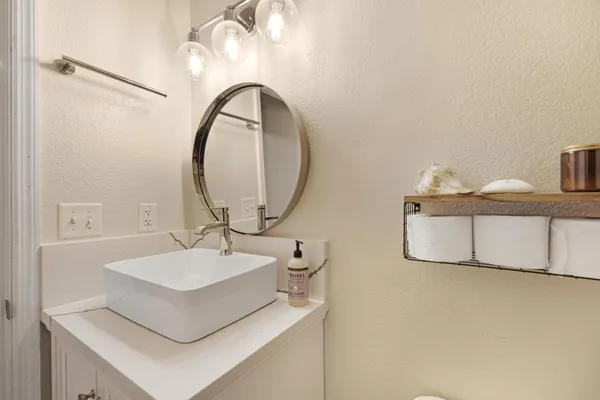 a bathroom with a sink and a mirror