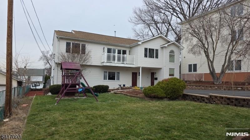 342 Sherman Street Passaic, NJ 07055 - Photo 1 of 32 a view of a house with a yard and a tree