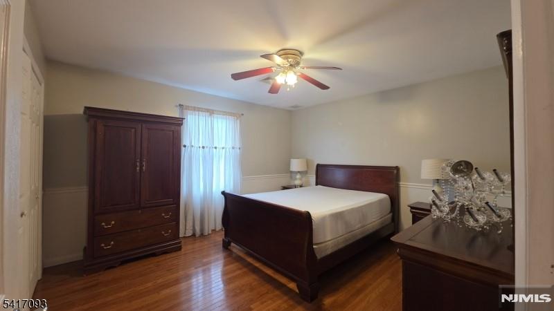 342 Sherman Street Passaic, NJ 07055 - Photo 12 of 32 a bedroom with a bed and wooden floor