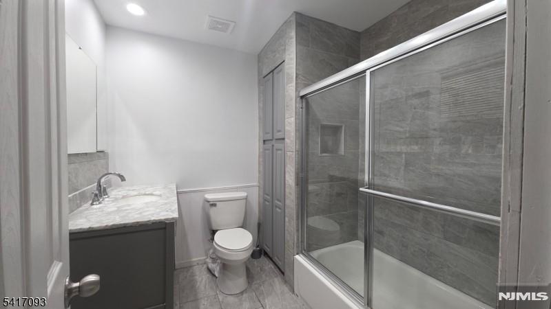 342 Sherman Street Passaic, NJ 07055 - Photo 20 of 32 a bathroom with a granite countertop sink toilet and shower