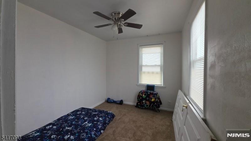 342 Sherman Street Passaic, NJ 07055 - Photo 21 of 32 a bed room with a bed and a window