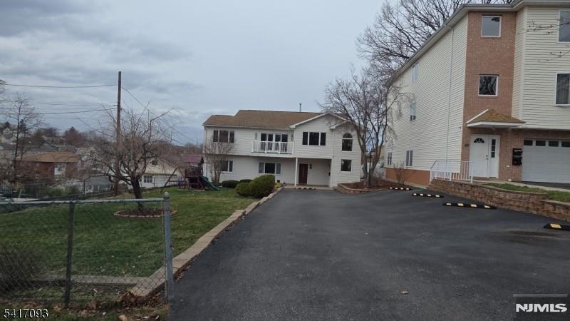 342 Sherman Street Passaic, NJ 07055 - Photo 27 of 32 a front view of a house with a garden and tree