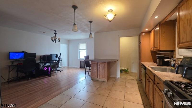 342 Sherman Street Passaic, NJ 07055 - Photo 29 of 32 a kitchen with sink cabinets and wooden floor